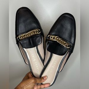 Black mules with chunky metal chain.